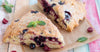 Berry scones, on brown paper bag on colorful table