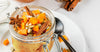 Pumpkin pie porridge in a mason jar, covered with seeds and pumpkin