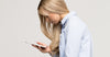 Woman hunched over looking at phone