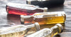 Glass bottles filled with various vinegars laying on table