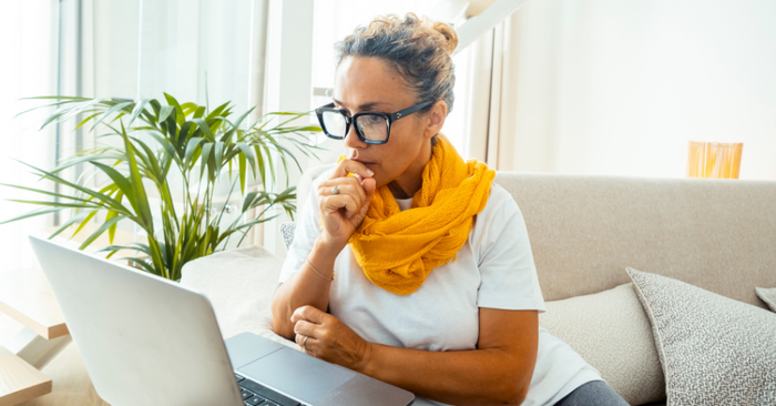 woman sitting at table on computer