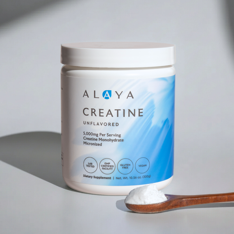 Alaya Creatine supplement container with a wooden scoop on a light gray background